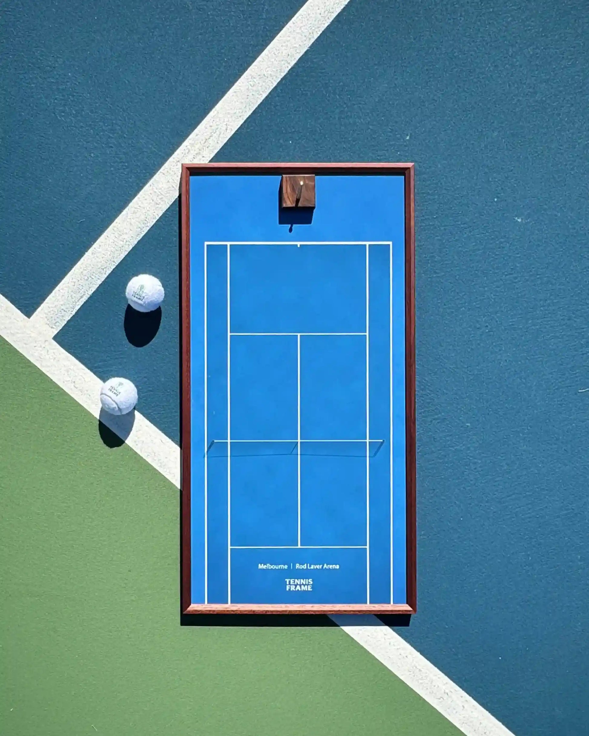 Australian Open Tennis Frame with Rod Laver Arena blue court background, flat lay on outdoor tennis court with two balls