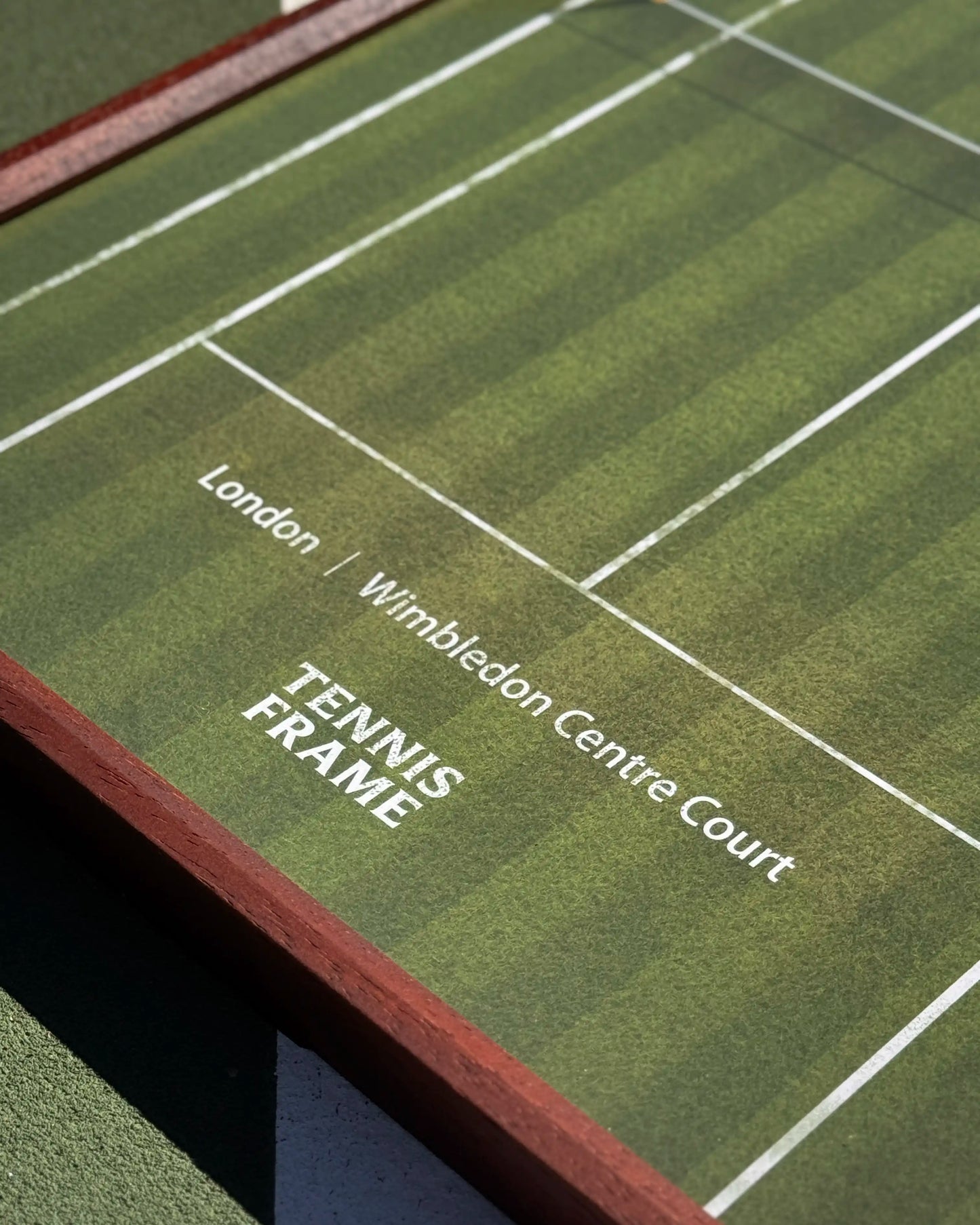 Close-up of Wimbledon Centre Court text and grass texture on tennis frame, premium printed court design