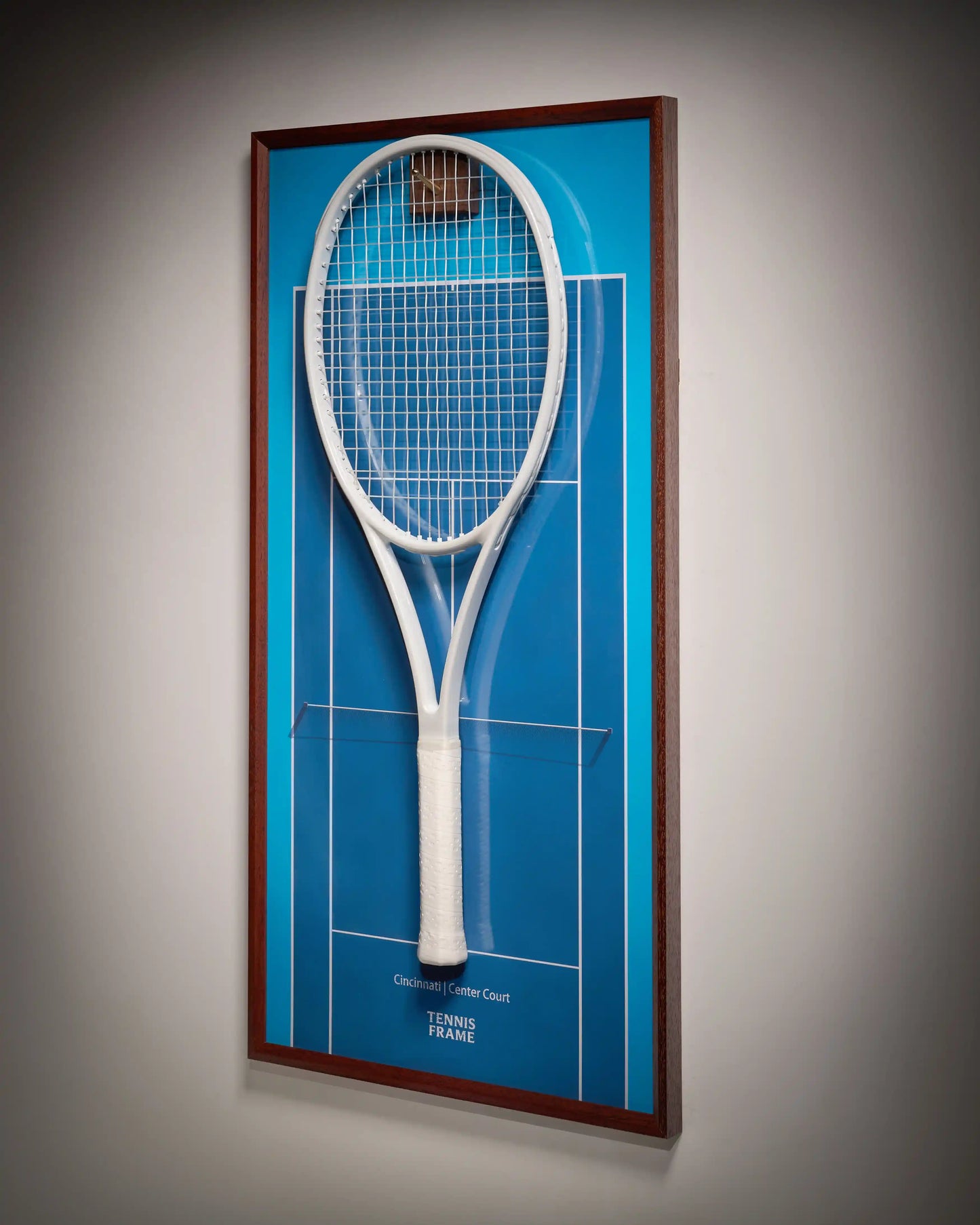 Cincinnati Open Center Court tennis racket display frame with blue hard-court background and walnut wood, three-quarter angled view with white racquet