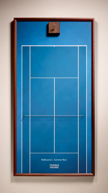 Front view of the Melbourne Summer Blue empty tennis racket display frame featuring a walnut wood frame, brass hook, and blue hard court design for modern home decor.