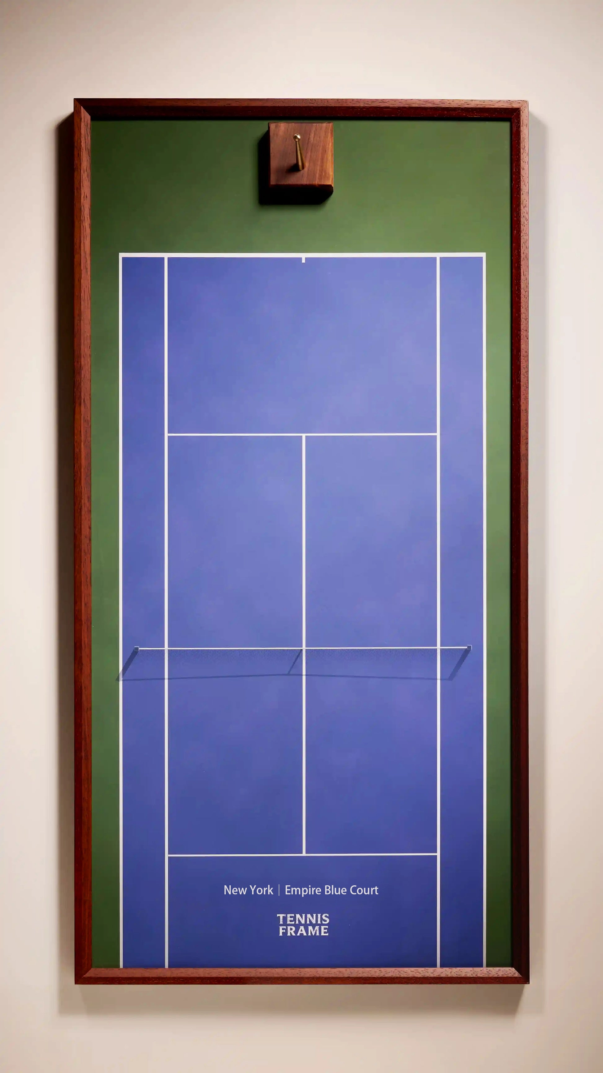 Tennis Frame New York Empire Blue Court tennis racket display frame with walnut wood frame, brass hook, and blue hard court background for displaying a tennis racket.