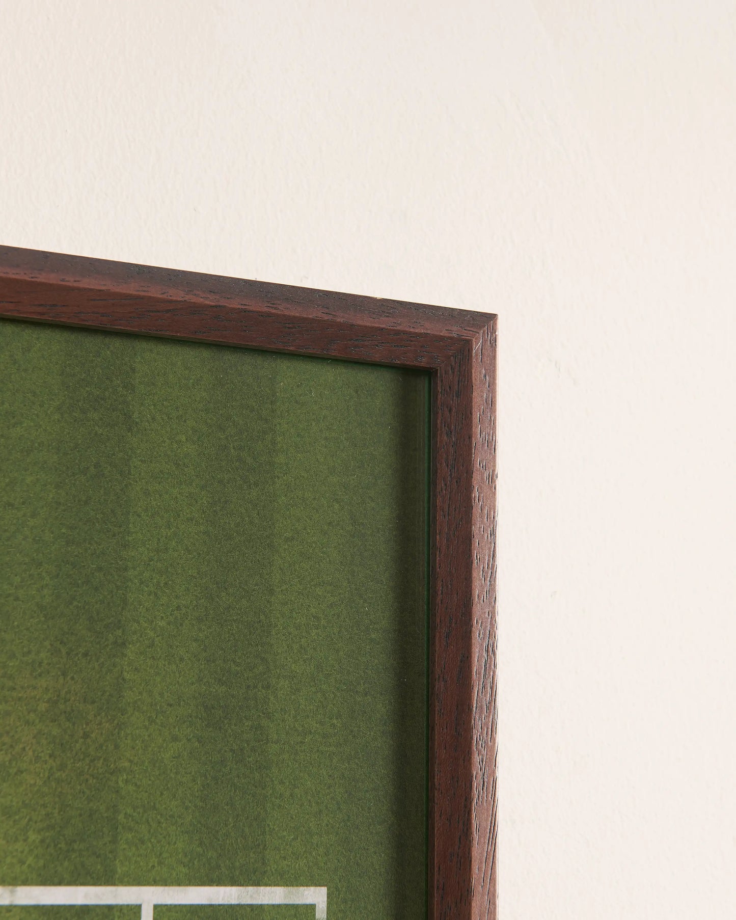 Close-up of walnut wood frame corner with Wimbledon grass court texture, highlighting premium craftsmanship