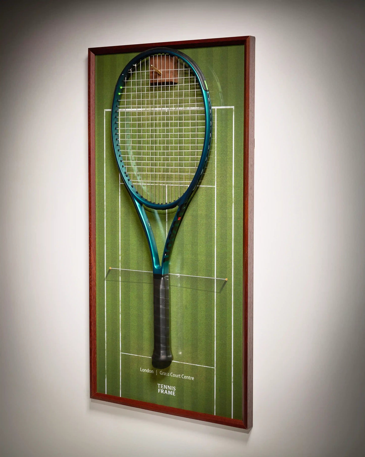 Wimbledon Tennis Frame on grass-court background with walnut hook and hanging racquet, three-quarter angled product view.